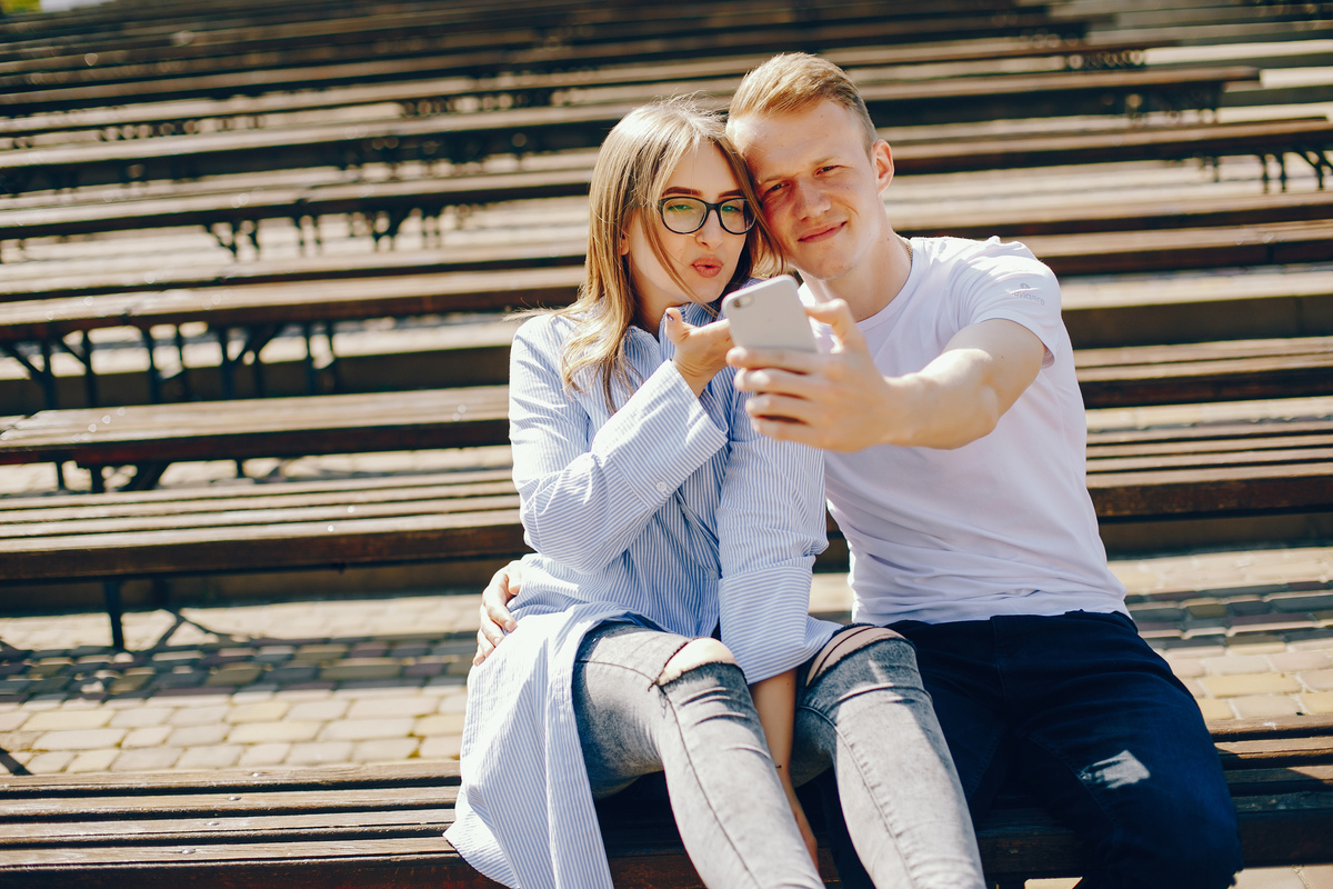 A couple sitting together on a park bench